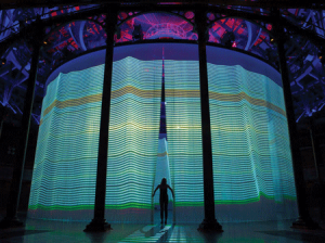 A visitor walks through the silicone threads of 'Curtain Call' at the Roundhouse theater in London. All images courtesy of Ron Arad.