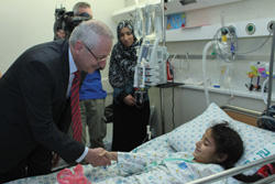 Dr. Hani Abdeen (left) meets with a young patient at Hadassah Hospital.