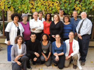 Michele Bashan-Haouzi (far left), Dr. Shlomo Maayan (third from left), Estelle Rubinstein (third from right) with AIDS center staff.