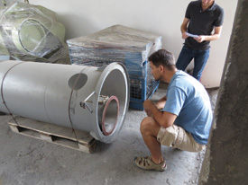 Milk and Honey Cofounder Simon Fried, inspecting a still.