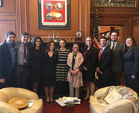 Natalie Portman and Ruth Bader Ginsburg stand in the middle of the justice's 2015 law clerks. Image courtesy of Mary Hartnett.